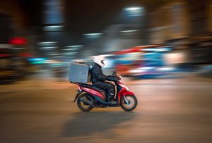Man driving a delivery scooter 